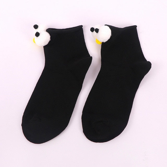 Womens black cartoon socks with eyes and nose.