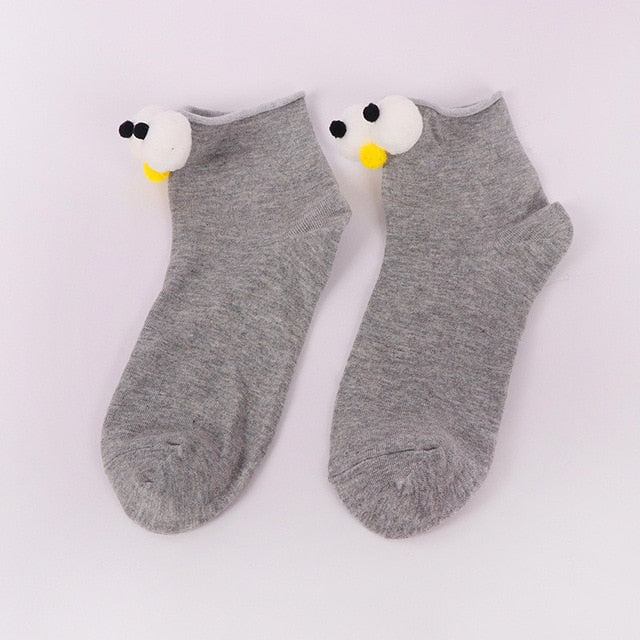 Womens grey cartoon socks with eyes and nose.