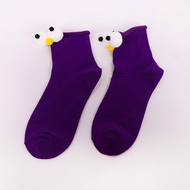 Womens purple cartoon socks with eyes and nose.
