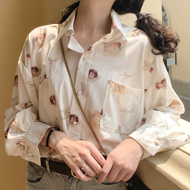 Women's cream color button up blouse with angels and doves print.