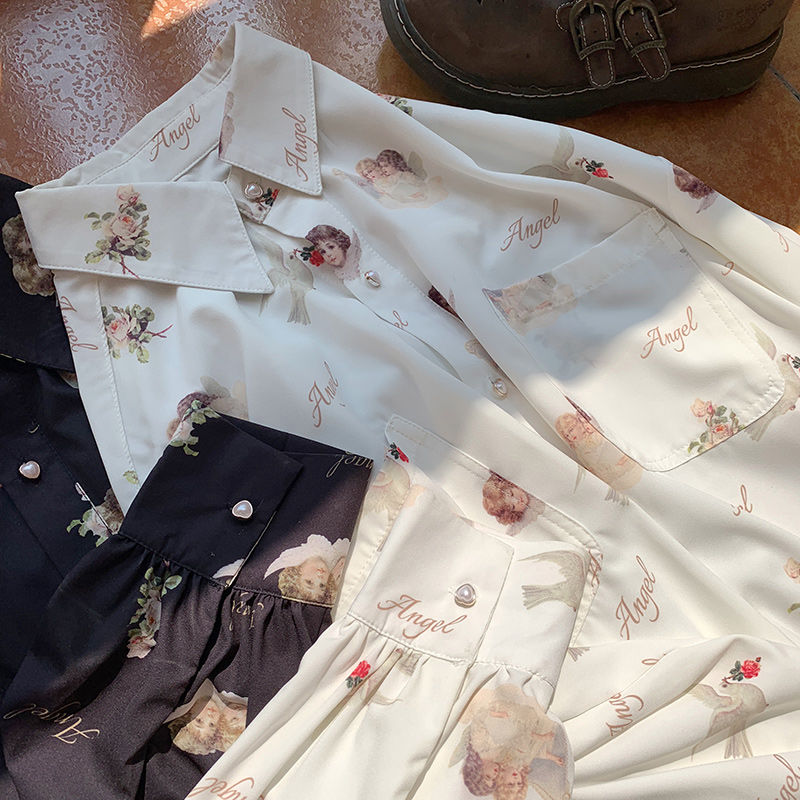 Women's cream color button up blouse with angels and doves print.